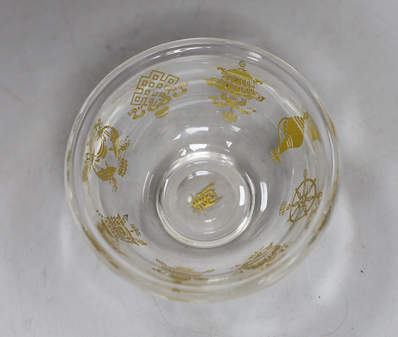 A Tibetan glass dish with gilt interior decoration. 9cm diameter